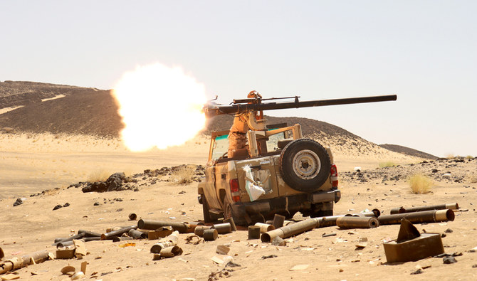 A Yemeni government fighter fires a vehicle-mounted weapon at a frontline position during fighting against Houthi fighters in Marib, Yemen, March 9, 2021.