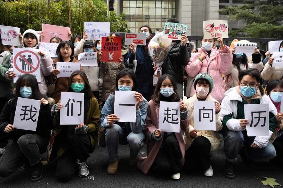 Chinese #MeToo activists displaying posters outside court in Beijing